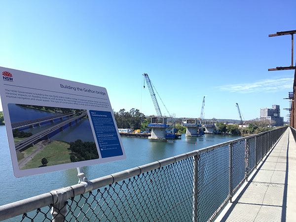 Signage on the existing bridge explaining the building of the new bridge (October 2018)