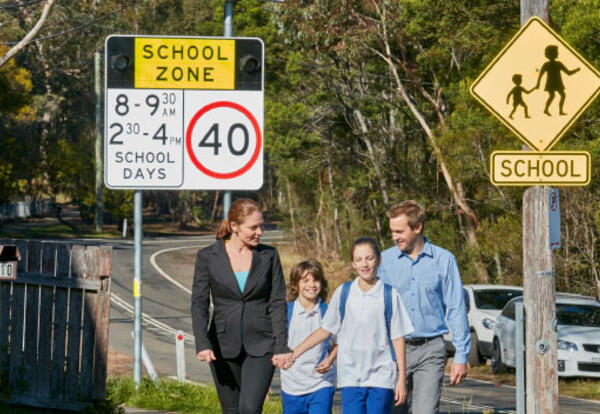Parents walking with their children in a school zone