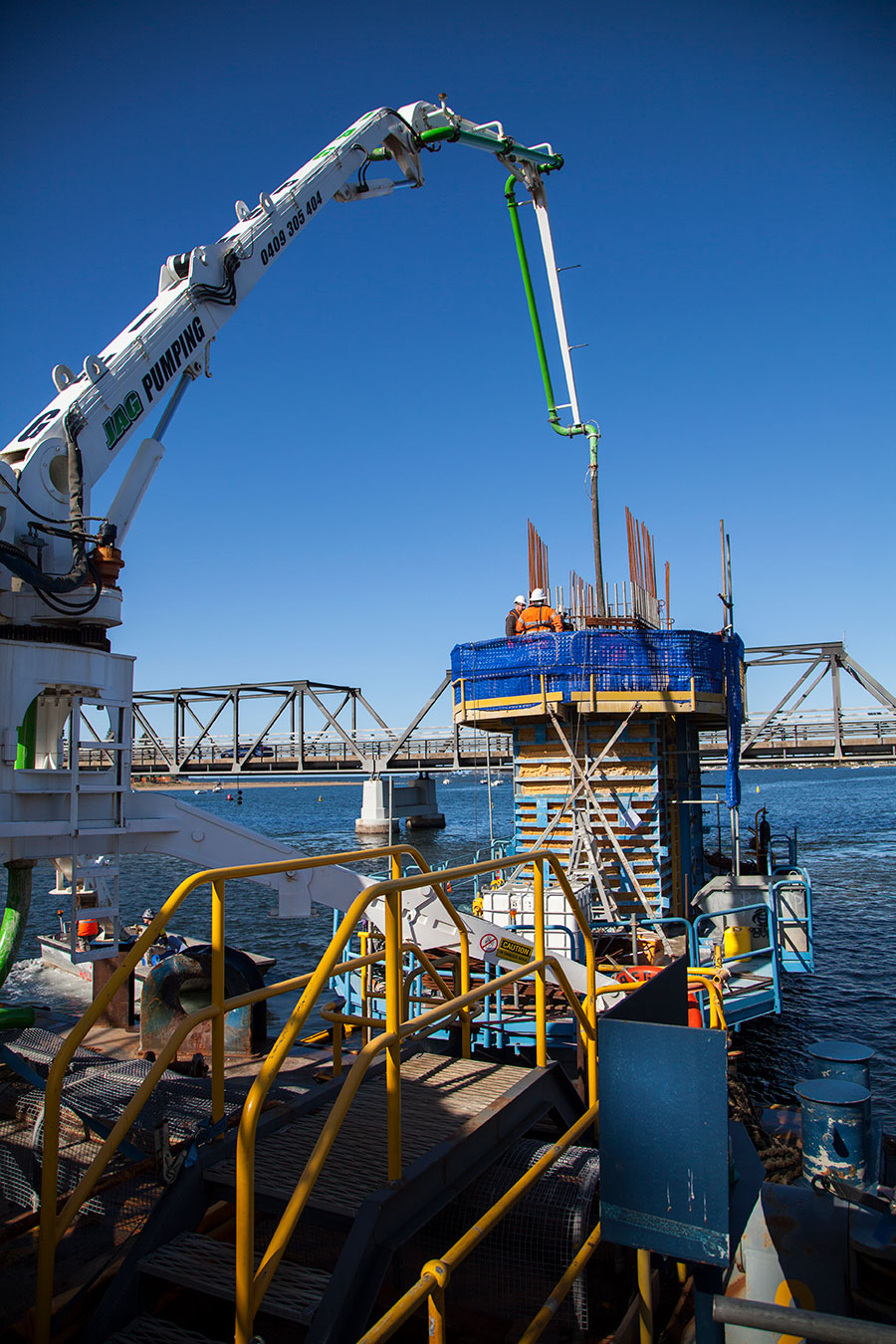Pouring concrete for substructure on river via barge May 2020