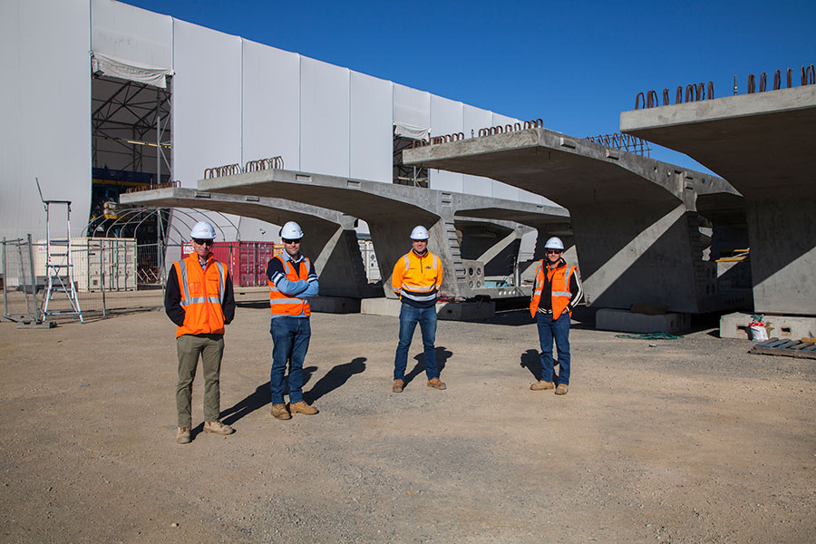 Bridge engineers in pre-cast facility storage yard May 2020