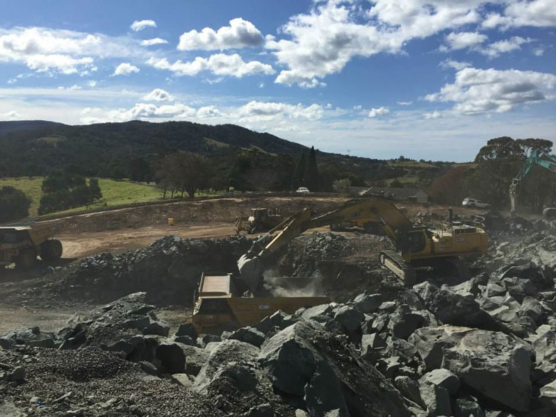 An 80 tonne excavator loading rock into a dump truck at Toolijooa Ridge - August 2015