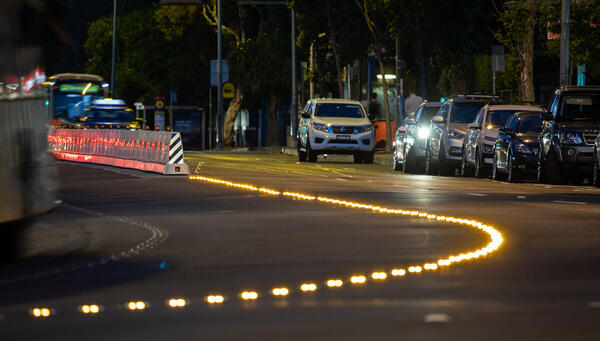In-pavement lights assist motorists to understand when lane changes are in operation during AM and PM peak traffic periods.