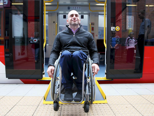 Man in wheelchair on train platform