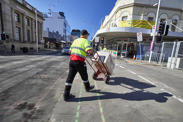 Man with trolley delivering boxes in Parramatta CBD.