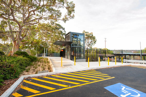 Image of station entry with lift and wheelchair accessible parking space
