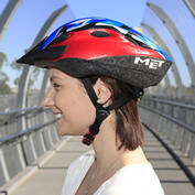 Side on view of a woman wearing a helmet with the straps joining in a "V" just below the ears