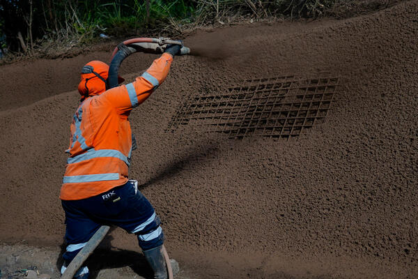 Transport for NSW Workers sprayed almost 2,000 square metres of concrete onto the unstable slope located about one kilometre downhill from the hairpin bend.