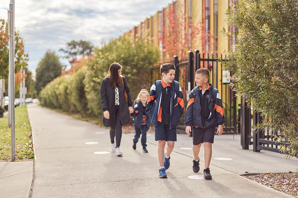 Transport for NSW Three children and one adult walking to school.