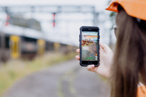 Rail maintenance engineer undertaking track maintenance with augmented reality app