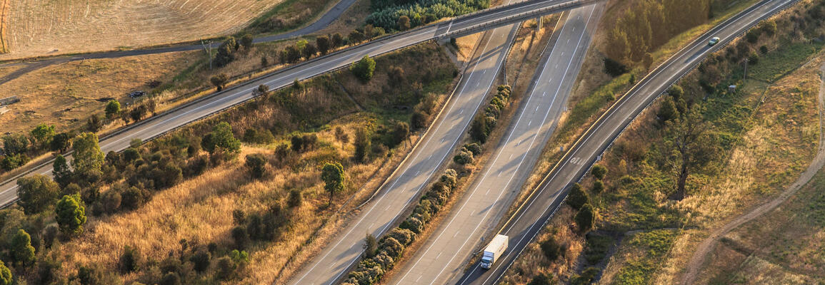 Transport for NSW Aerial view of freight truck passing by Hume Highway (M31) and Strut Highway (A20) interchange.