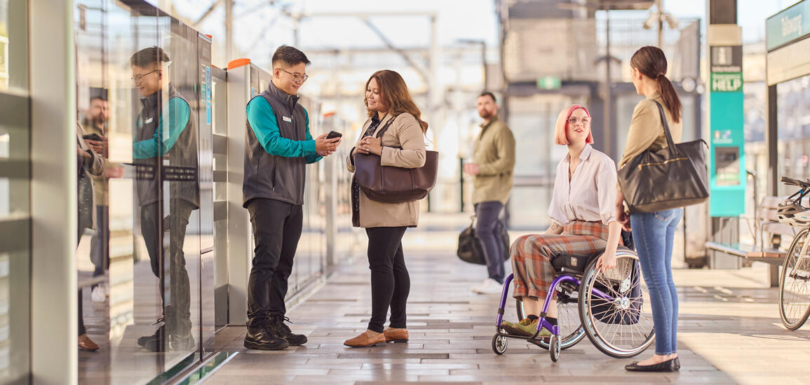 Transport for NSW Sydney Metro staff assisting passengers on platform at Rouse Hill metro station.