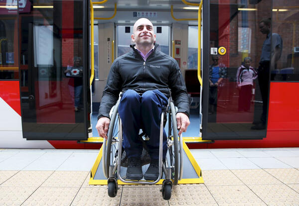 Man in wheelchair on train platform