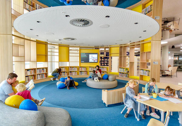 interior of public library with children reading