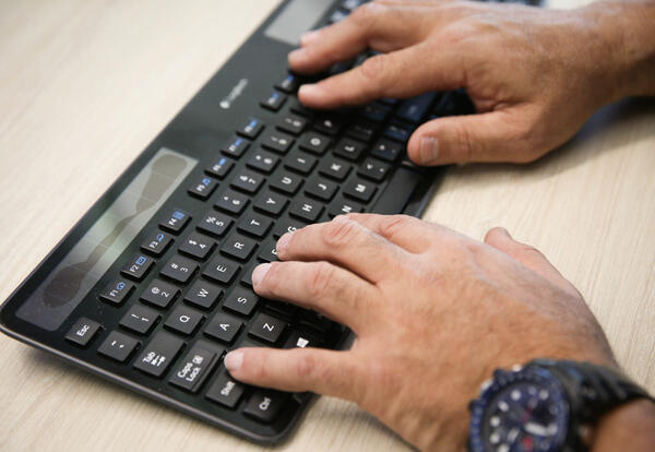 main typing on computer keyboard