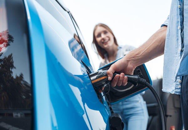 Customers charging an Electric Vehicle 