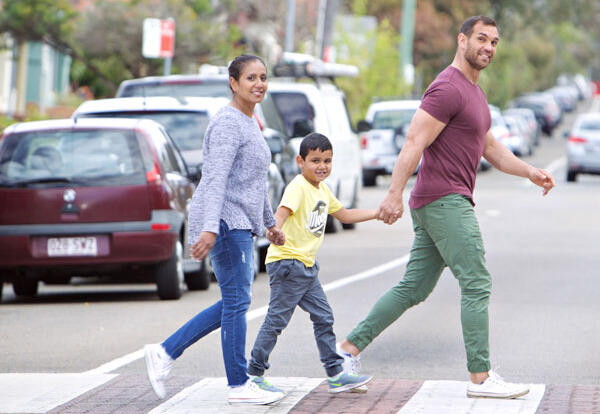 A family using a pedestrian crossing 