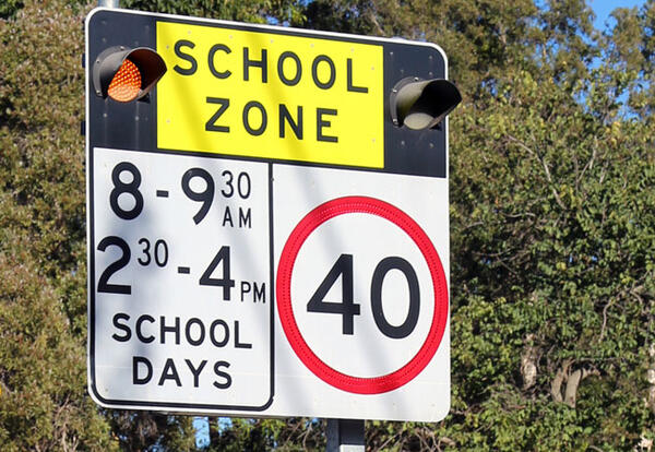 School Zone sign with flashing lights