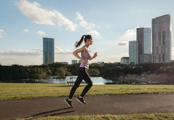 woman jogging in urban parkland