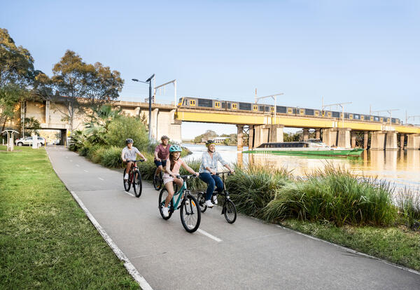 Transport for NSW Family riding bikes alongside Parramatta River at Meadowbank.