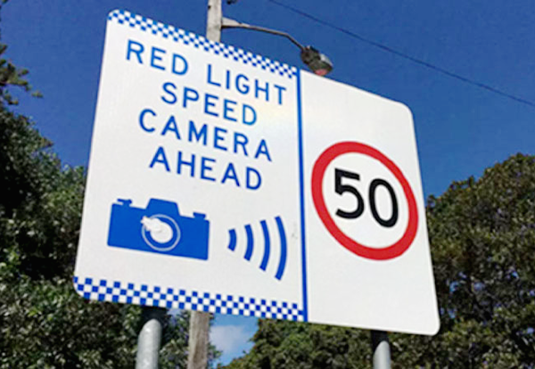 Sign: red-light speed camera ahead