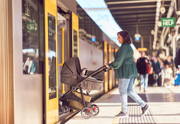 East West Rail Link - passenger boarding train with pram